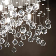 Close-up of Ideallux MOONLIGHT chandelier with crystal and gold accents, featuring dimmable 8 lights and sparkling crystal droplets.