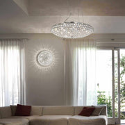 Elegantly lit room featuring the Ideal Lux King Ø65cm pendant light with sparkling crystals and adjustable height.
