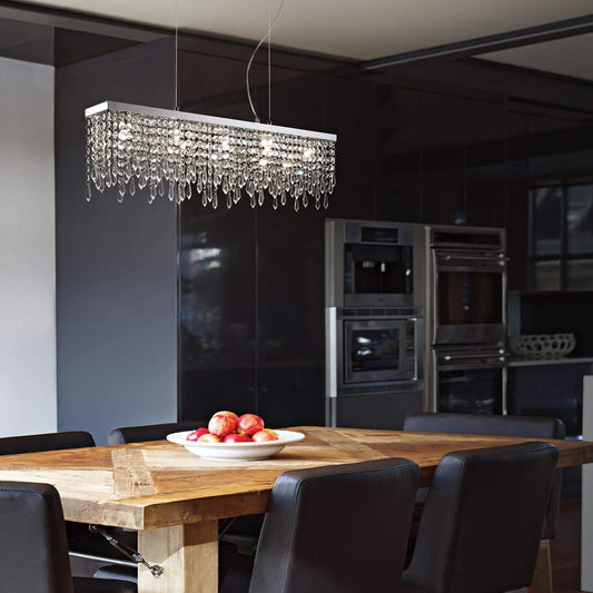 Modern kitchen featuring Kristall Pendelleuchte GIADA CLEAR with sparkling lead crystals, chromed finish, illuminating a wooden dining table.