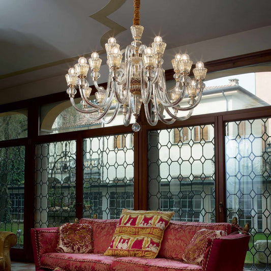 Elegant Strauss chandelier with 18 hand-blown glass lights, chrome and crystal arms, illuminating a luxurious living room.