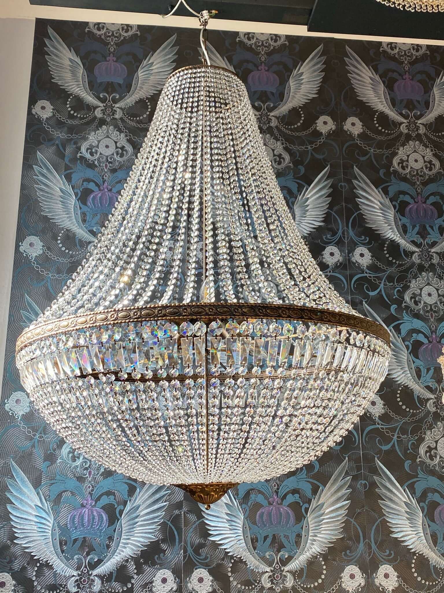 Luxurious antique-style crystal chandelier with intricate basket design, perfect for adding elegance to any room with its dazzling sparkle.