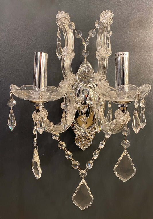 Elegant 2-light wall sconce with sparkling lead crystals and chrome finish, featuring intricate details and crystal glass arms.