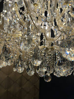 Close-up of a luxurious chandelier featuring sparkling crystal elements and intricate design.