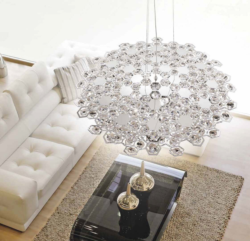 Luxurious KRISTALL Carnaby pendant light with dazzling cut crystals, adjustable height, 24kt gold, silver-chrome finish, in living room.