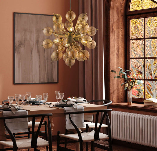 Dining room with Maytoni Glaskugel hanging light in amber above a table set for a meal, featuring glass elements and wooden decor.