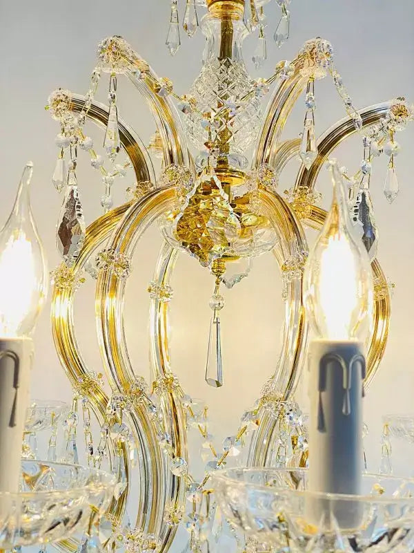 Close-up of Kristall Kronleuchter Mozart gold chandelier with crystal arms and LED lights