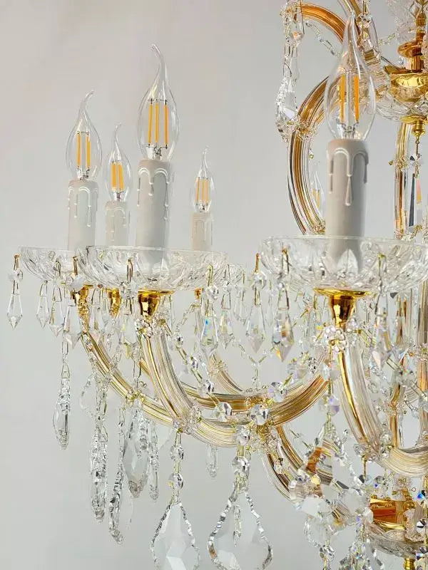Gold and crystal chandelier with 12 arms featuring gleaming crystal glass and dimmable E14 LED bulbs, elegant and classic design.