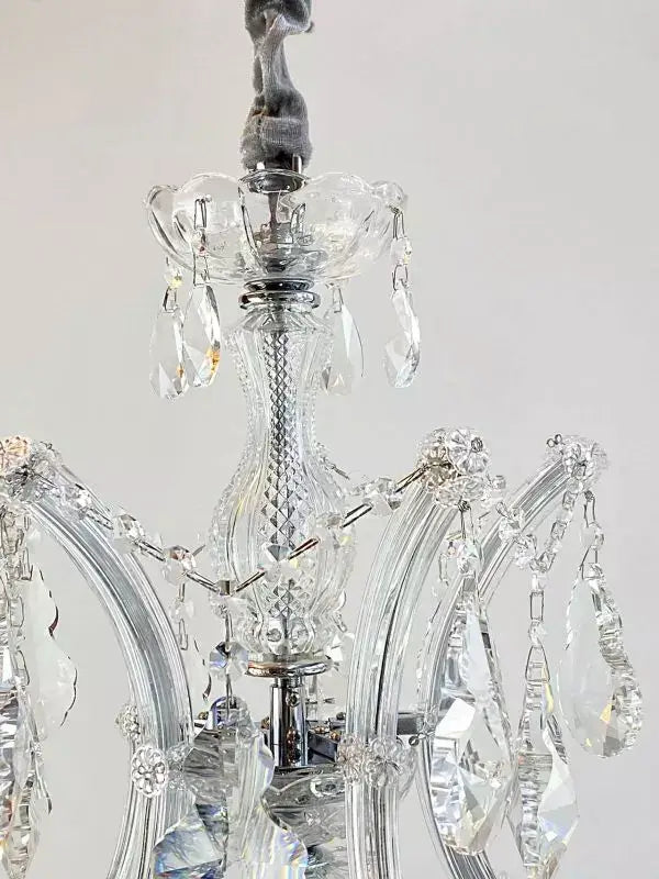 Close-up of elegant Beethoven crystal chandelier with silver finish, showcasing detailed cut crystal arms and hanging ornaments.