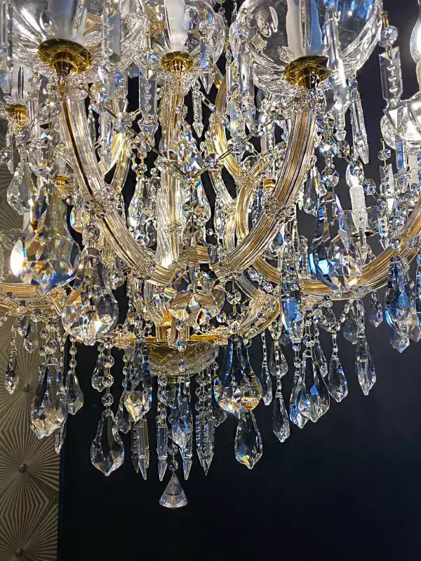 Exquisite gold crystal chandelier with intricate glass arms, adorned with sparkling crystals, called Michelangelo Ø95cm.