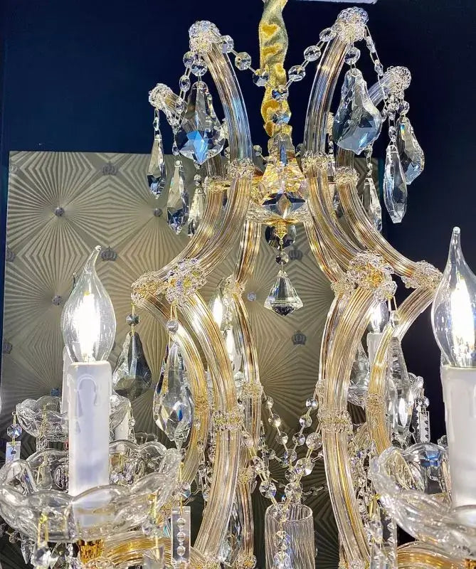 Close-up of the luxurious Michelangelo crystal chandelier with 19 elegant arms and gold finish, featuring intricate crystal details.