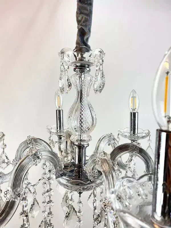 Close-up of Kristall Kronleuchter with crystal arms and LED bulbs, highlighting intricate design and craftsmanship.