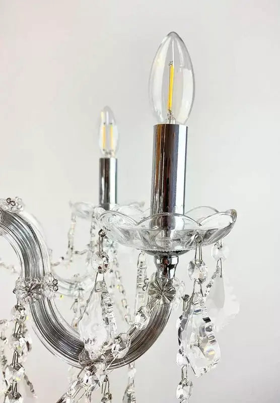 Close-up of Maria Theresia chandelier arm with crystal glass detailing and LED bulb holder, showcasing elegant design and craftsmanship.