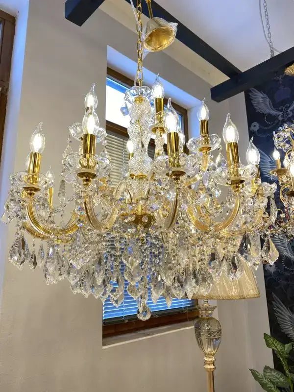 Gold crystal chandelier with 18 lights and shimmering crystals, Ø77cm, dimmable, Maria Theresia design, in elegant room setting.