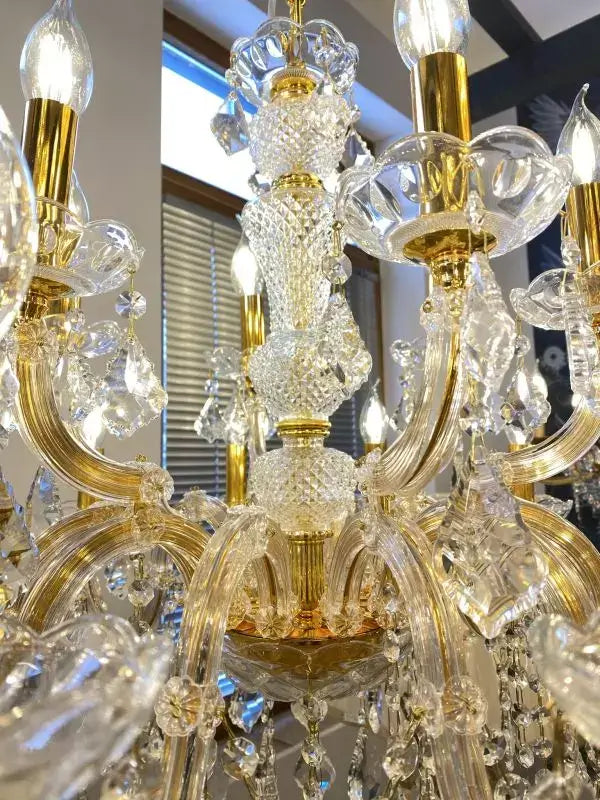 Gold crystal chandelier with 18 lights and sparkling glass elements, featuring intricate cut lead crystal and glass arms.
