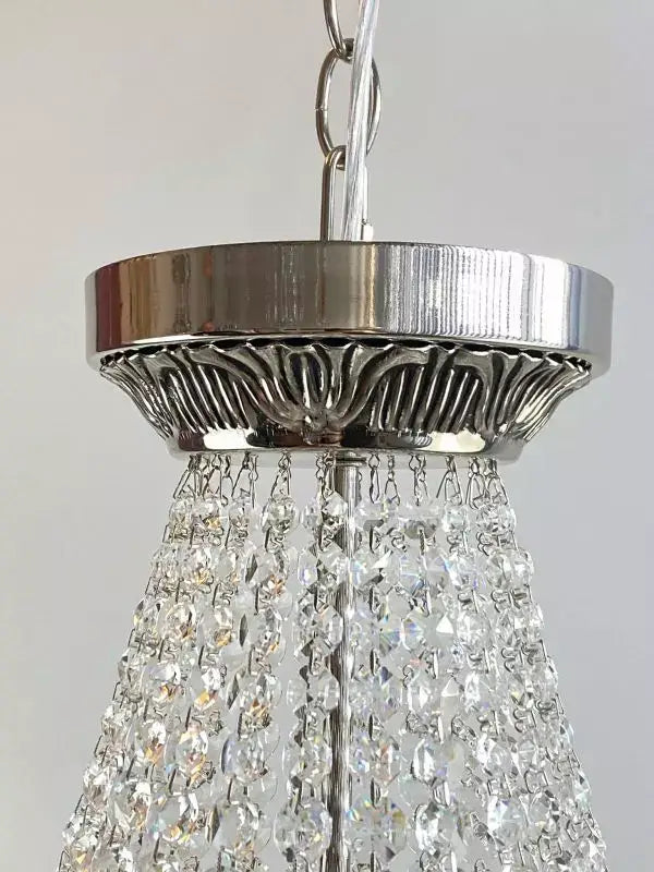 Close-up of Kristall Korblüster PLAZA chandelier with shimmering crystals and silver finish.