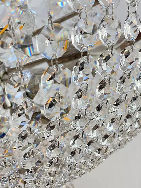 Close-up of sparkling cut crystal detailing on a silver Korblüster PLAZA chandelier, highlighting its intricate craftsmanship.