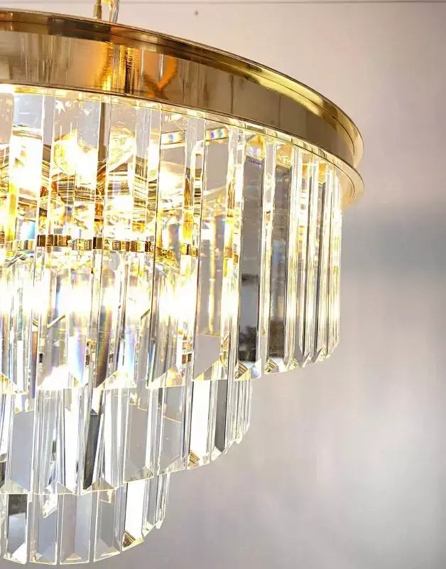 Elegant RIVA pendant light with gold brass frame, featuring sparkling crystal rods, Ø50cm, ideal for luxury interiors.