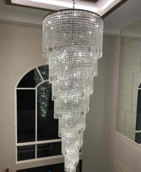 Luxurious Kristall Twister chandelier with spiral design, perfect for staircases, featuring brass, chrome, and high-quality lead crystal.